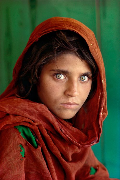 Afghan Girl is a 1984 photographic portrait of Sharbat Gula, also known as Sharbat Bibi, taken by photojournalist Steve McCurry. It appeared on the June 1985 cover of National Geographic. The image is of an adolescent girl with green eyes in a red headscarf looking intensely at the camera.